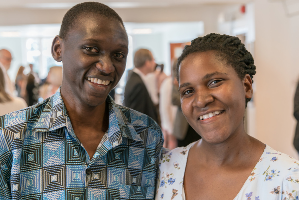 Man and woman smiling A couple stand next to each other smiling